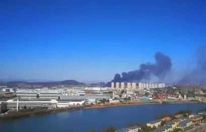 倉庫里往外冒著滾滾黑煙，把周圍的天空染上烏黑色。